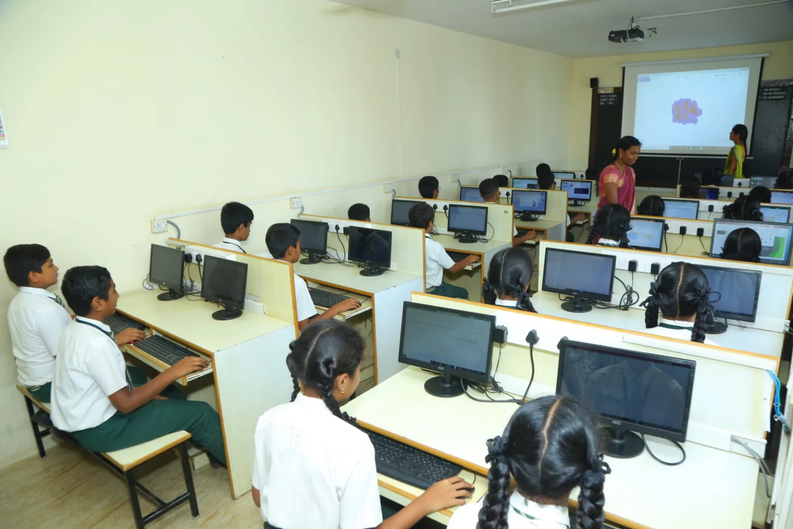 Students seated at computers in a well-equipped computer laboratory
