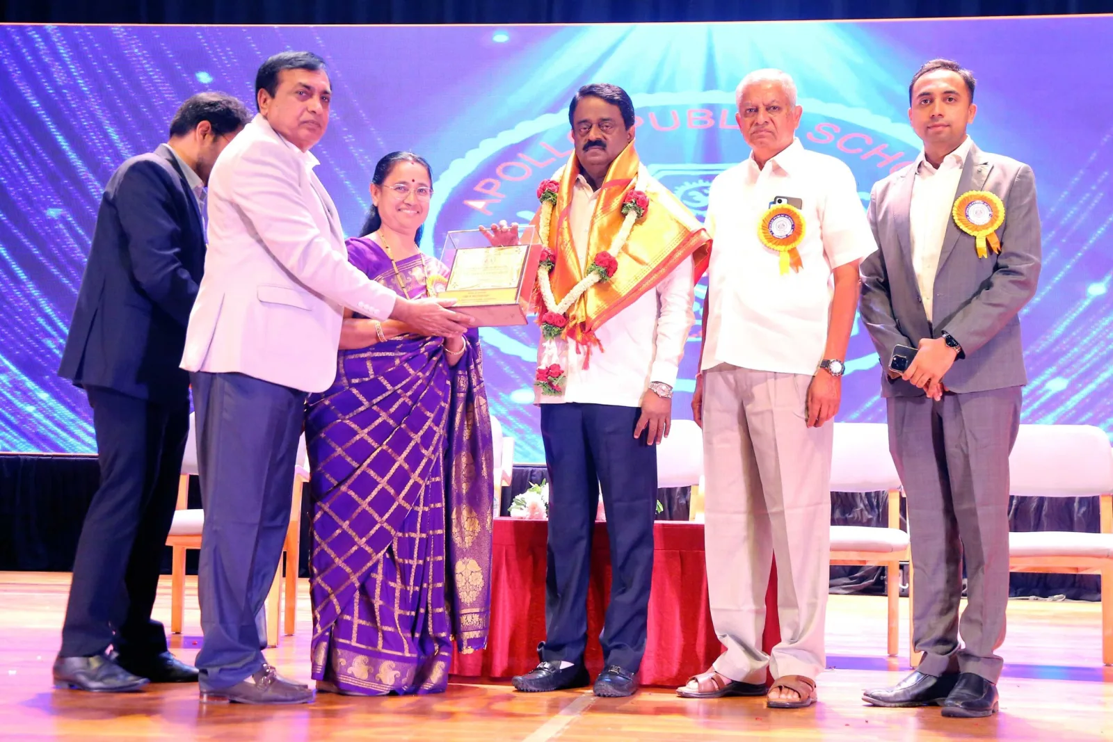 A guest of honour receiving a memento from school management on the Annual Day stage